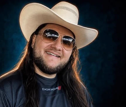 Kalani in his cream cowboy hat and aviators